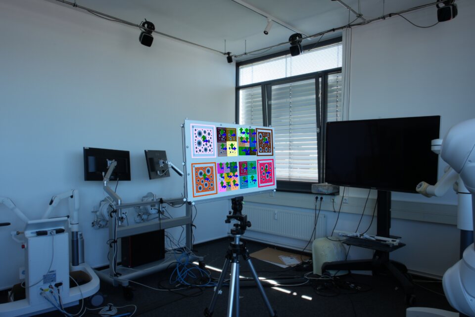 A rig of BlobBoards on a tripod in a motion-capture lab, with pose axes drawn on each detected board.